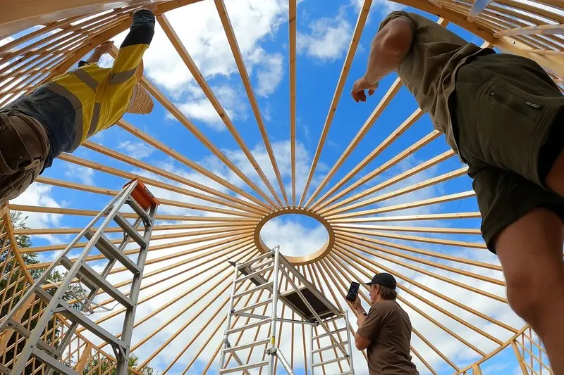 Looking up through the ORON yurt kit roof frame as our team fits the rafters to the crown ring