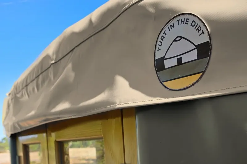 Close-up of a Bushland ORON wall and Sand Dune roof cover with the Yurt in the Dirt badge