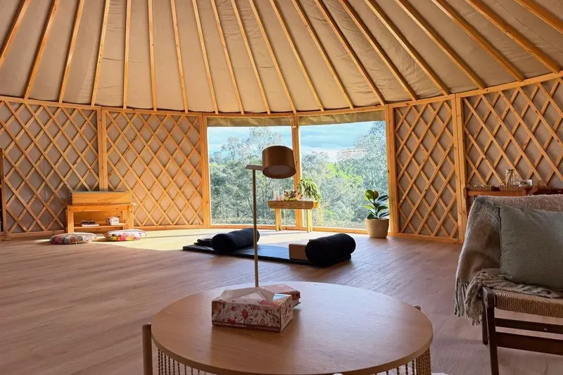 Furnished ORON interior with lattice walls, rafters and a big window to the trees