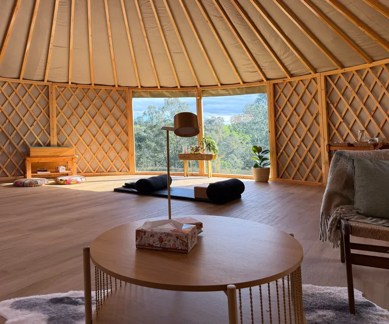 ORON interior set up as a yoga space, with a window onto the bush